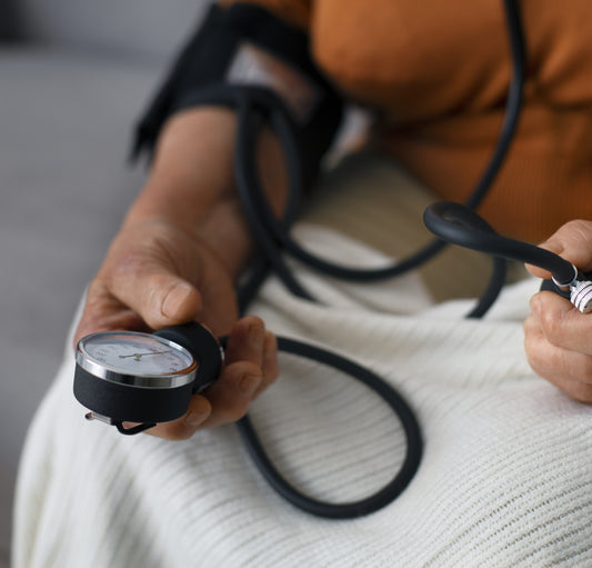 A person checking their blood pressure with a home monitor