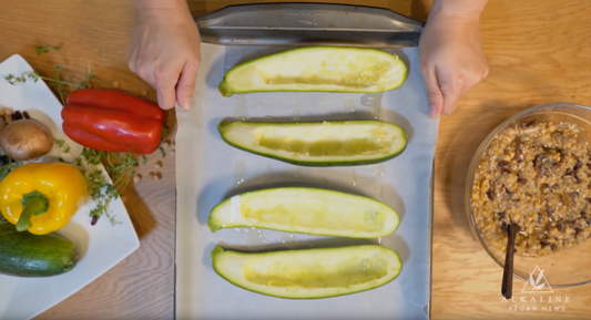 Bell peppers, zucchini, and filling on wood cutting table