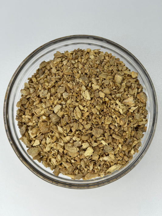 Dried ginger root, cut and sifted, in a glass bowl