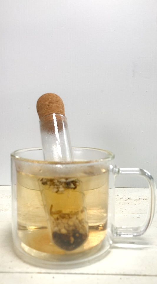 Cup of burdock and dandelion root tea beside dried cut roots
