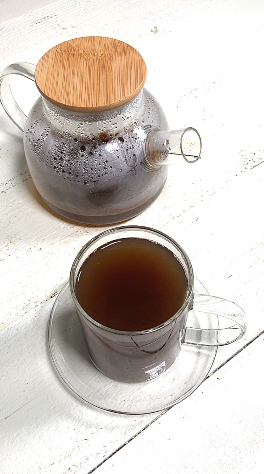 Cup of nettle, burdock root and sarsaparilla tea with the loose dried herbs