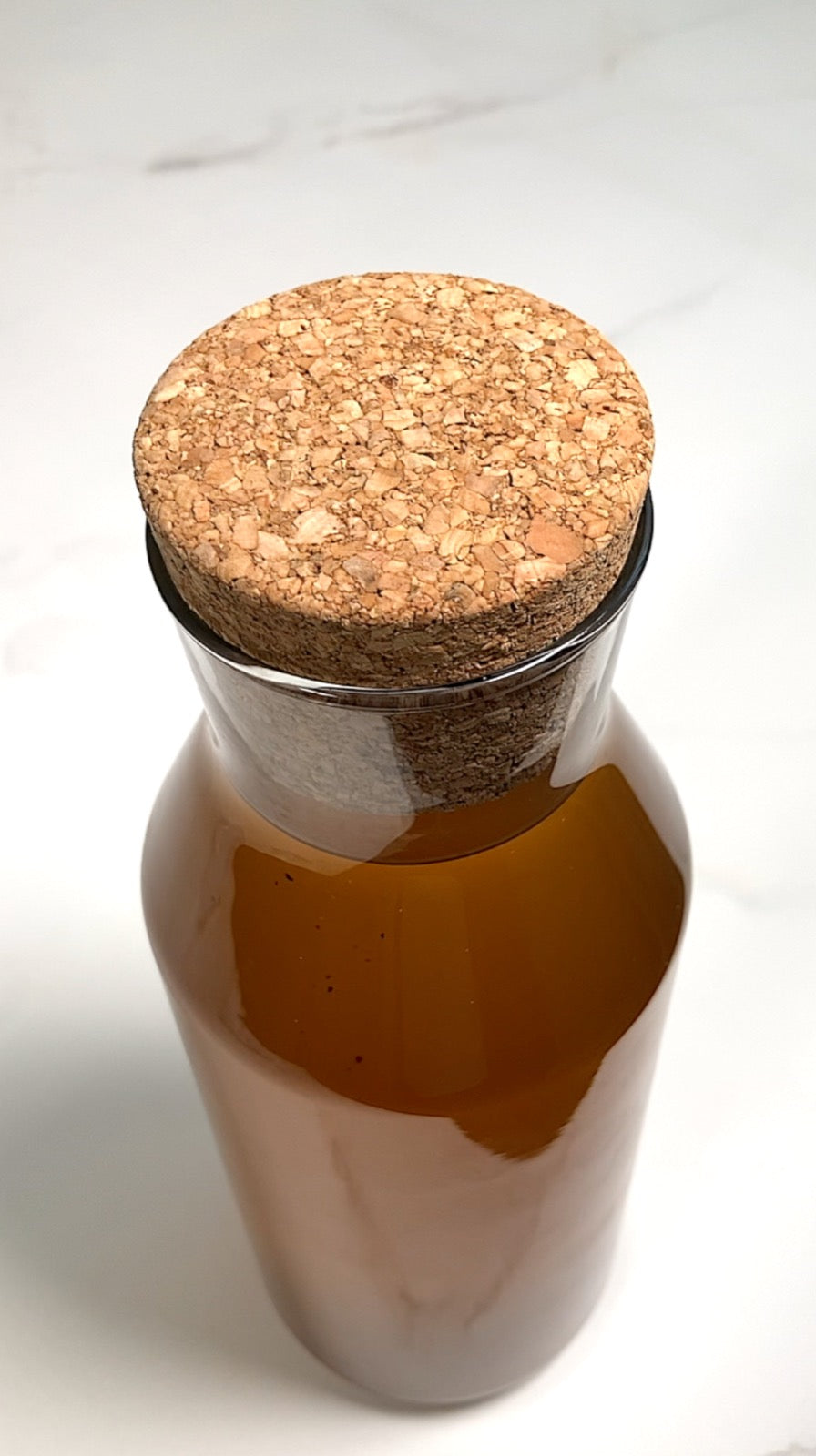 Cup of brewed palo guaco tea beside dried palo guaco leaf