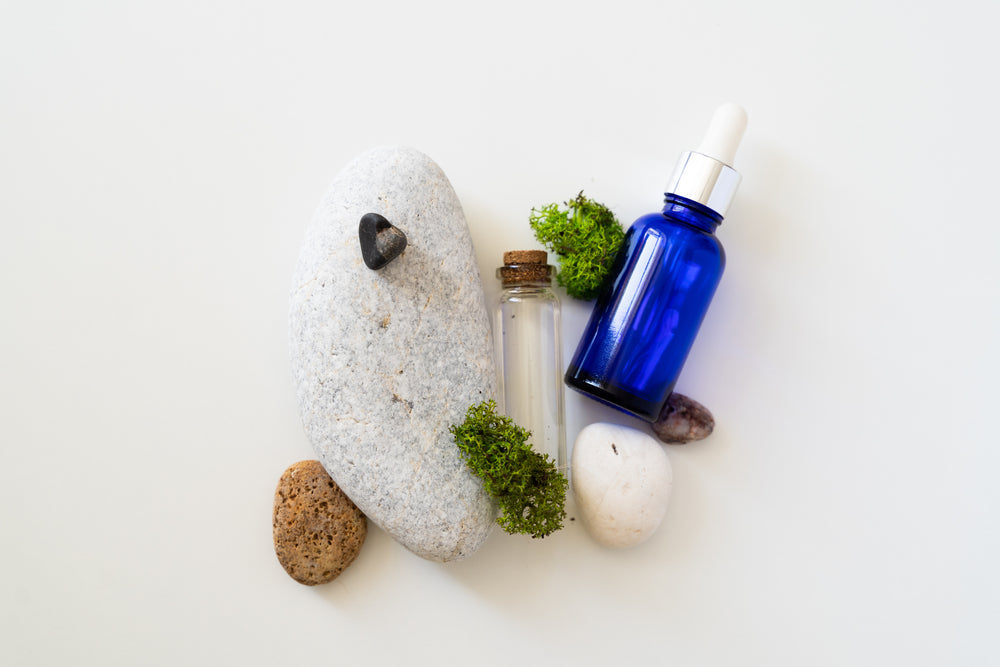 Spa stones and a dropper bottle with sea moss
